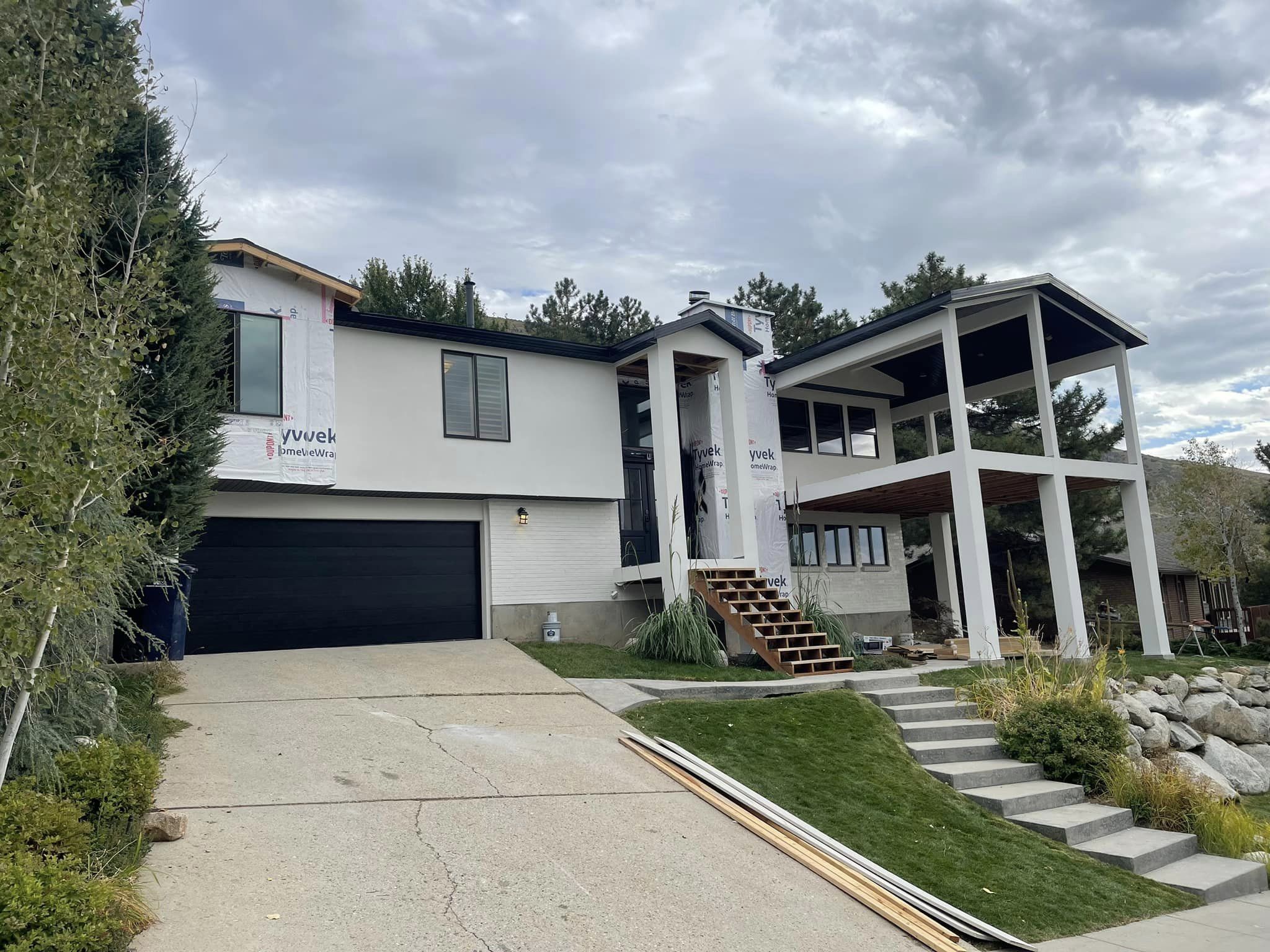 Raised entry home with stucco exterior work in progress